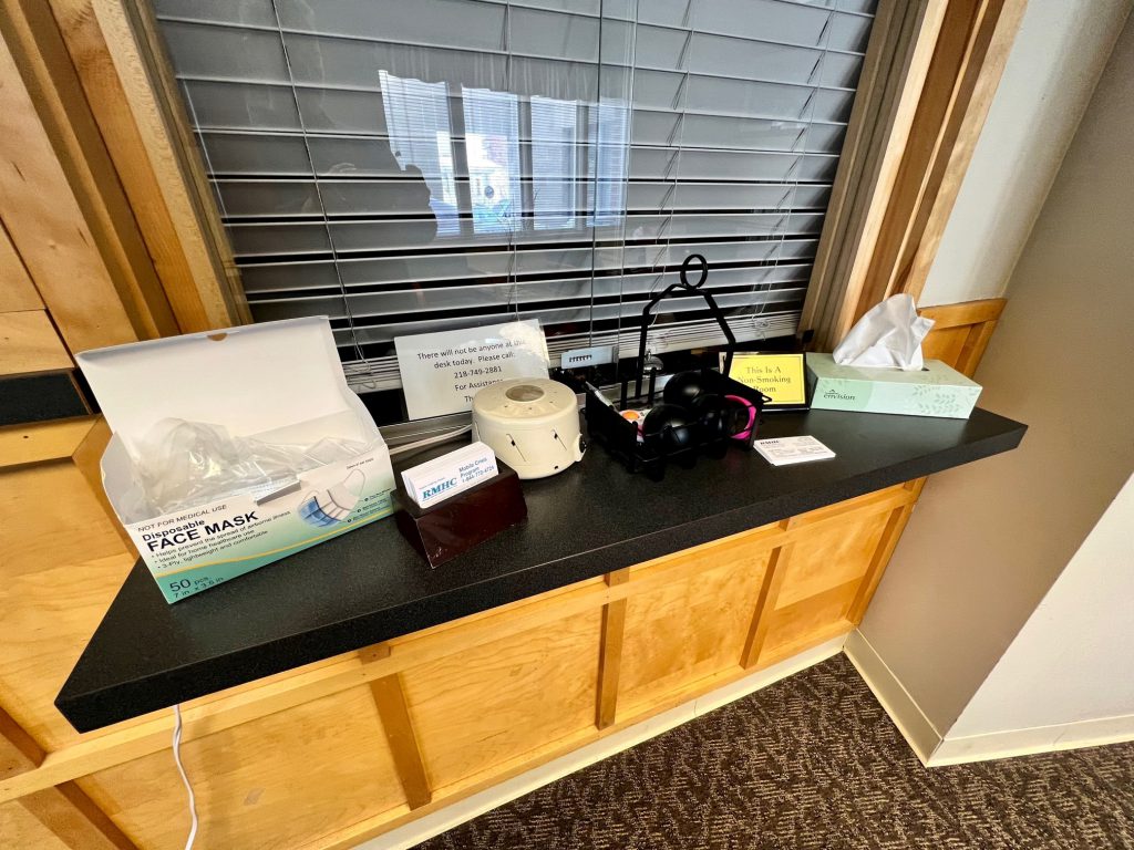 A countertop sits with facemasks, tissues, and an assortment of other items in the William J. Bell building.